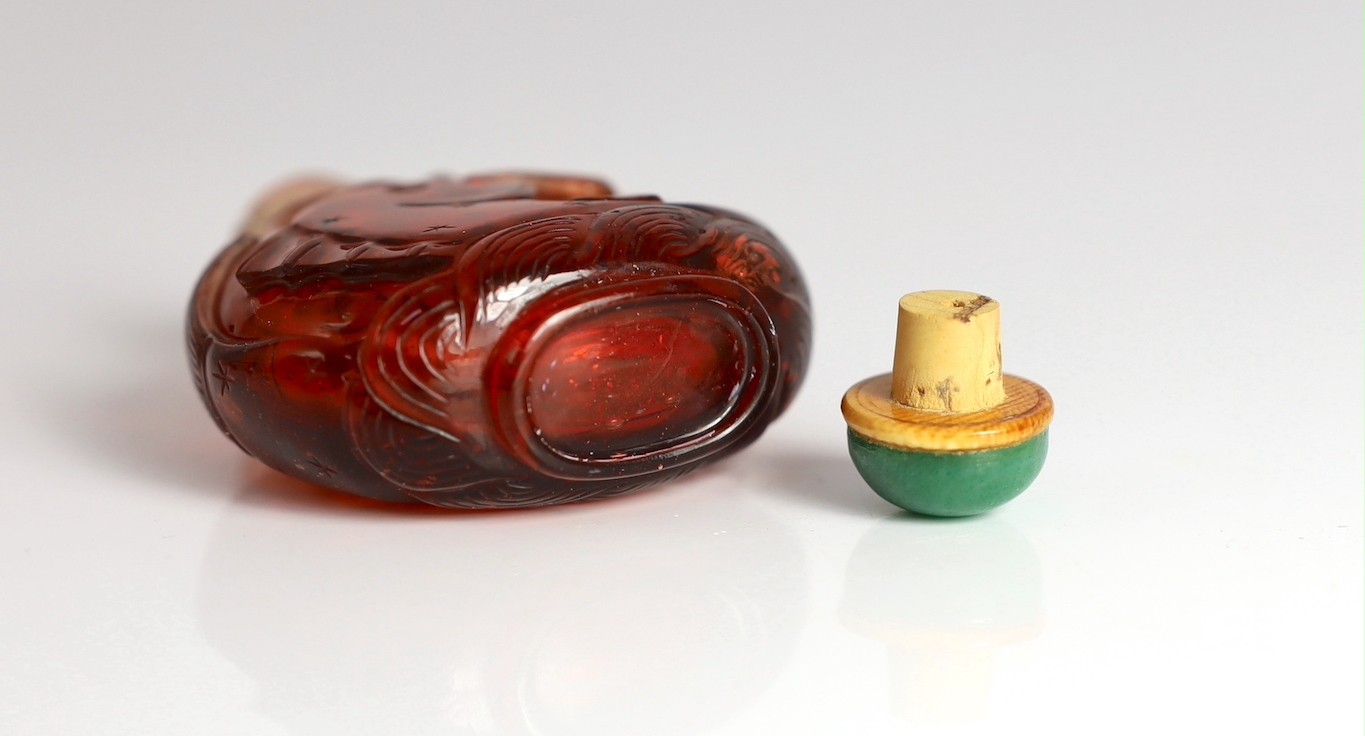 A Chinese ruby red glass ‘leaping carp’ snuff bottle, 1750-1850, 5.9cm high